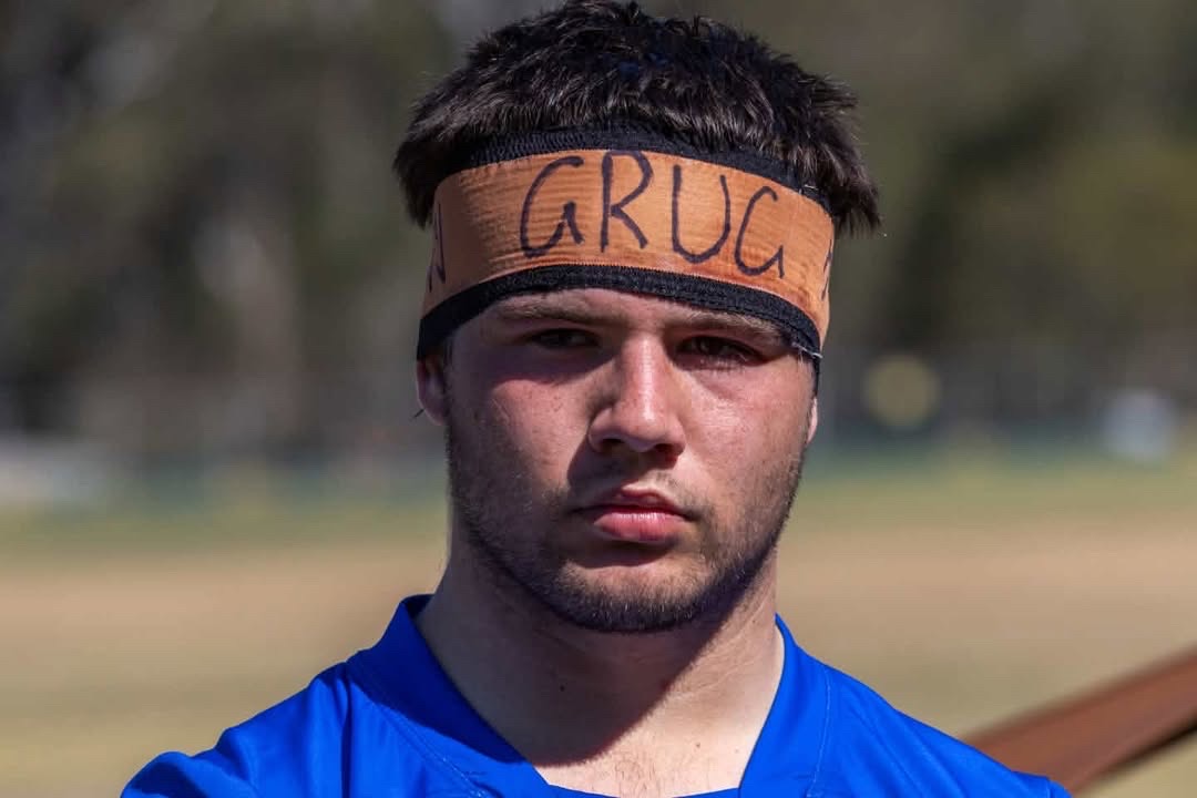 Close-up portrait of a rugby player wearing a handwritten headband